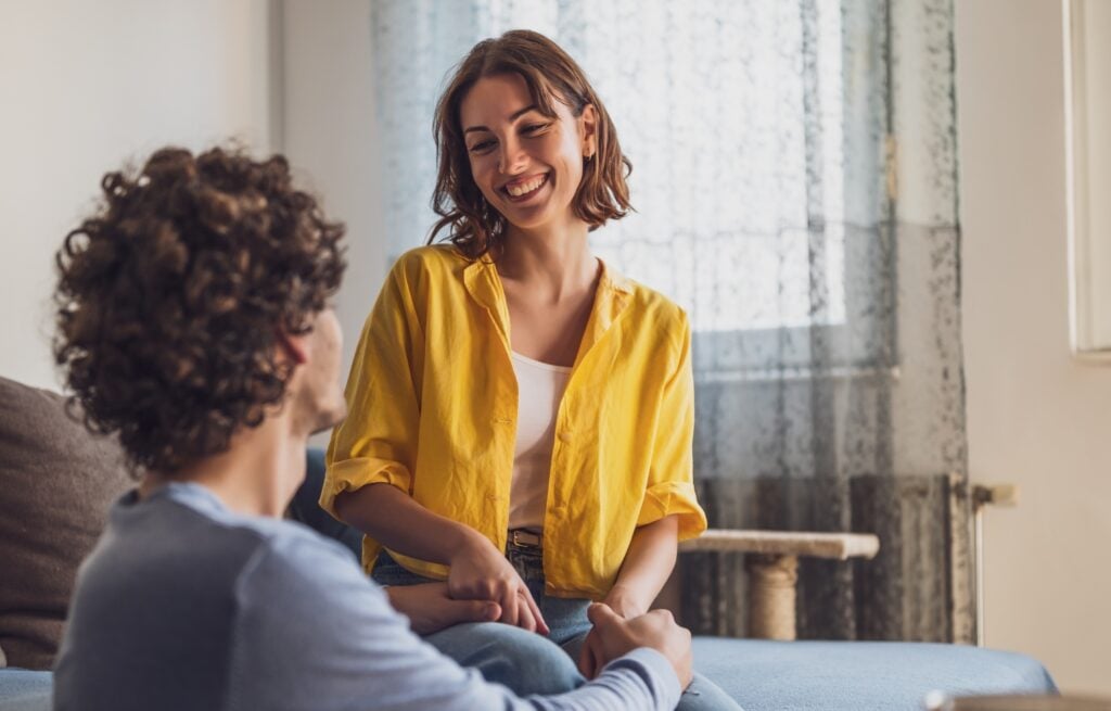 smiling woman while holding a partner's hand, concept of happiness and support