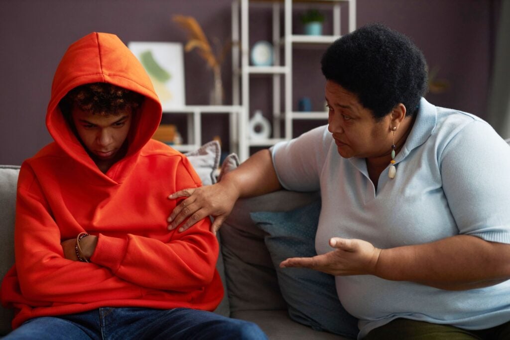 teenage boy having a deep conversation with mother about addiction and mental health struggles