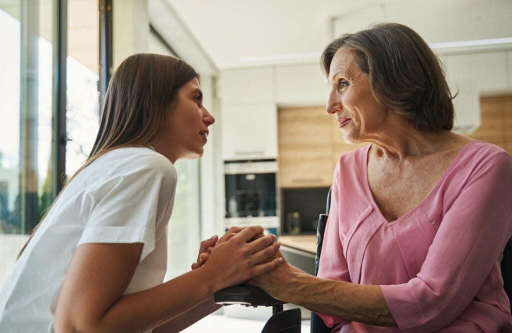 two women connecting through touch and conversation, concept of family values, health, wellness