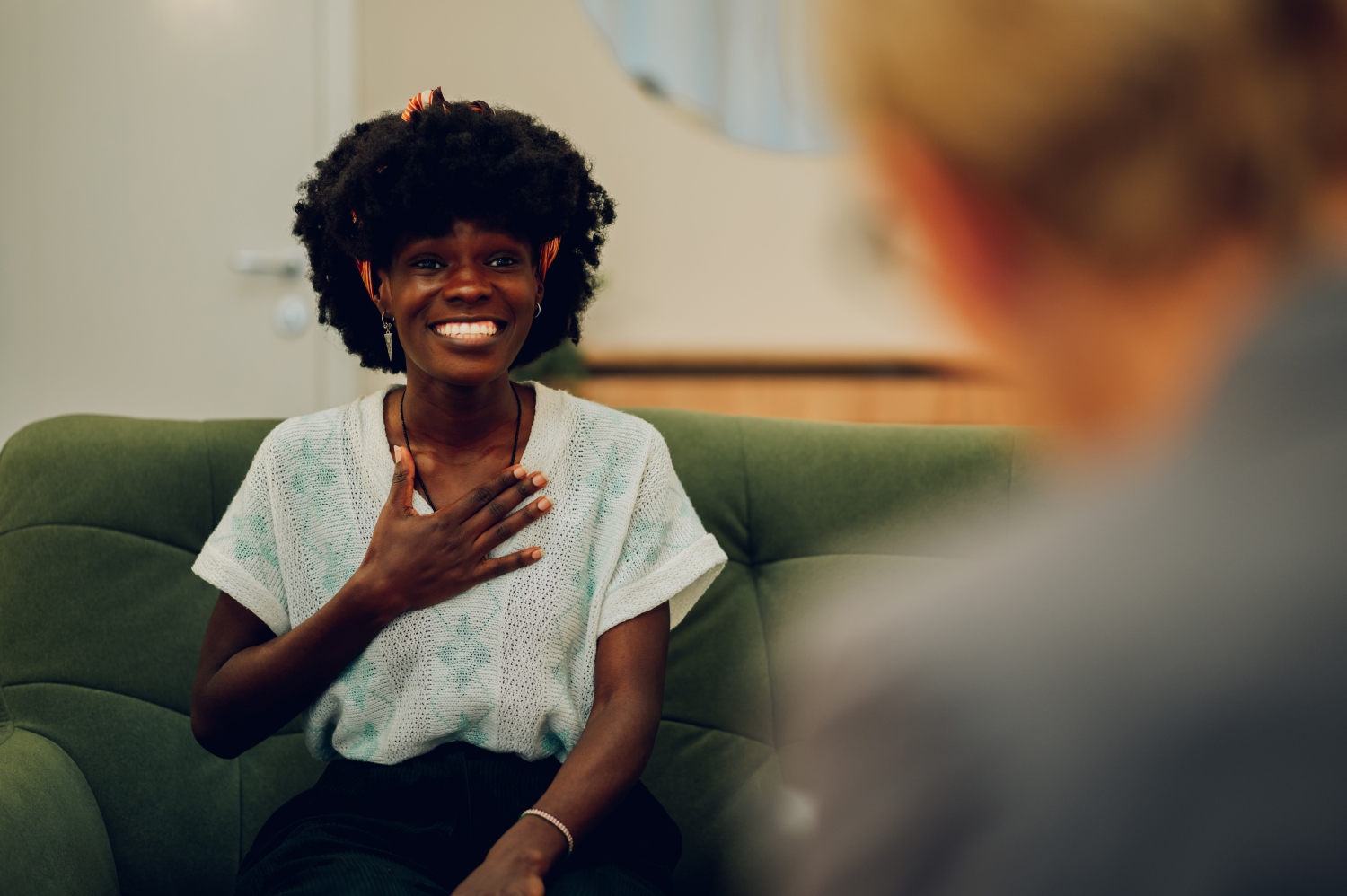 woman smiling while speaking to a therapist, concept of mental health, conversations, or human